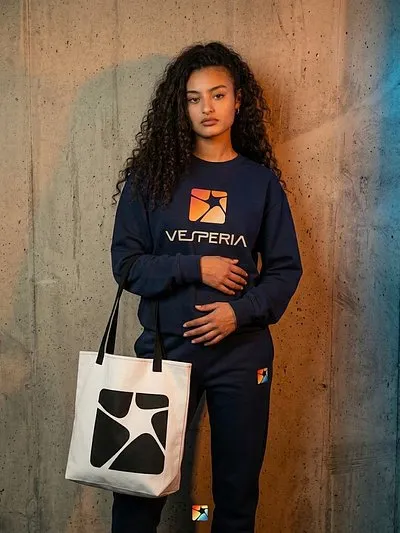Model in a navy Vesperia crewneck carrying the Vesperia tote