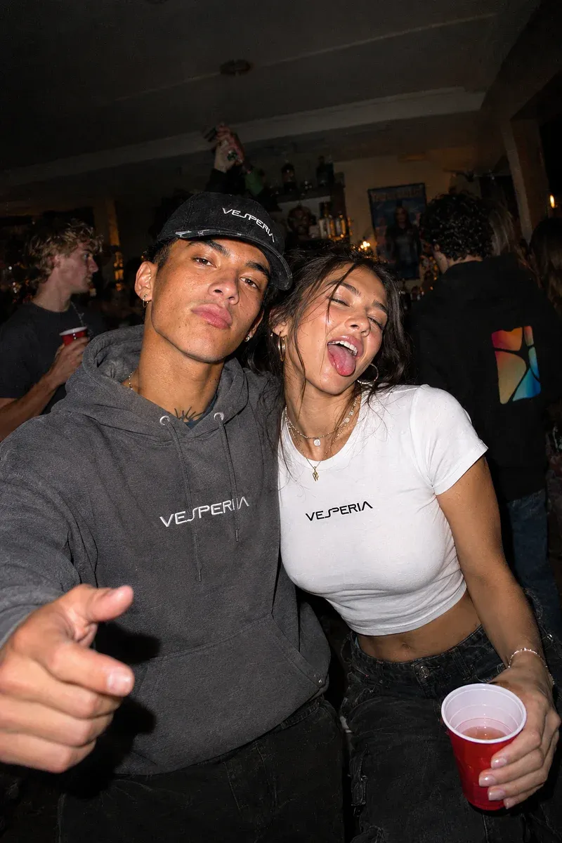 Friends in Vesperia hoodies and tees at a house party